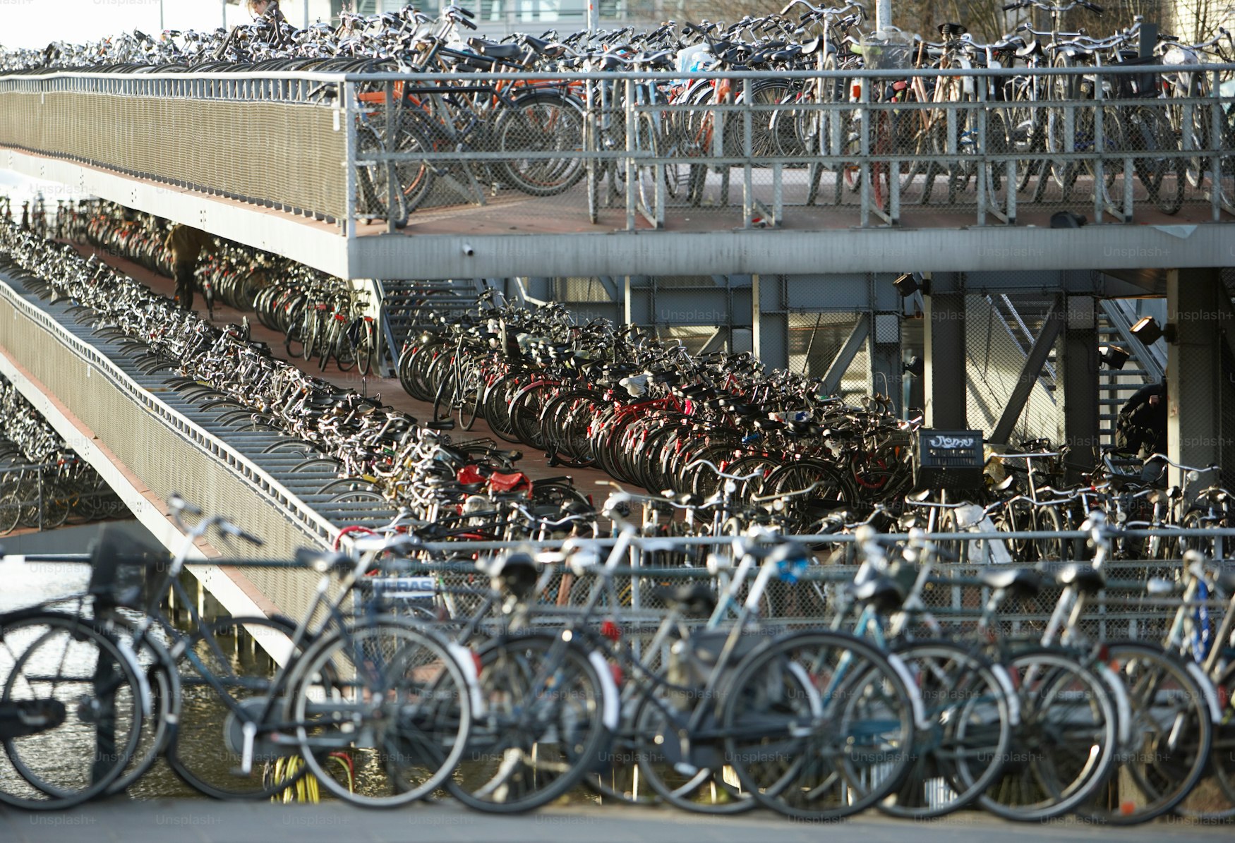Mmm, I wonder where I left my bicycle? A view of a really big amount of bicycles parked together.